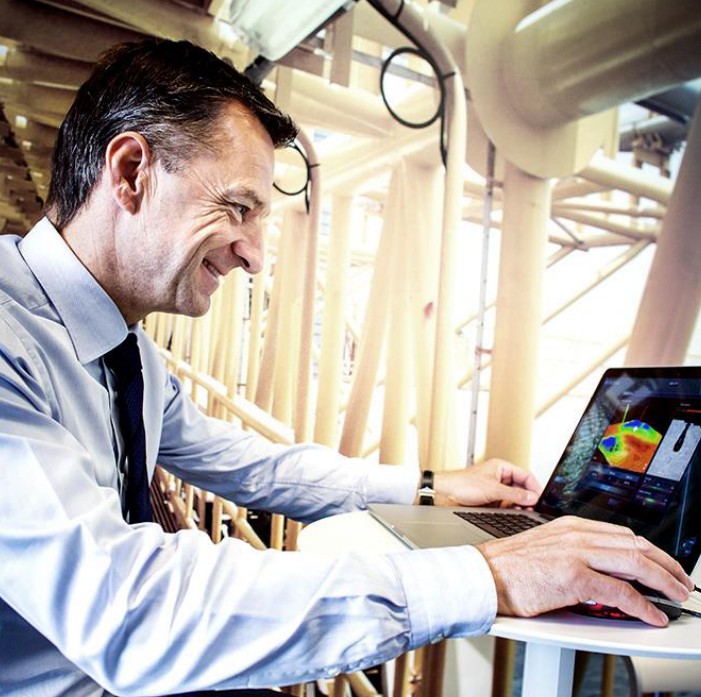 Claus V Hemmingsen CEO at Maersk Drilling sitting by a laptop at a construction ground